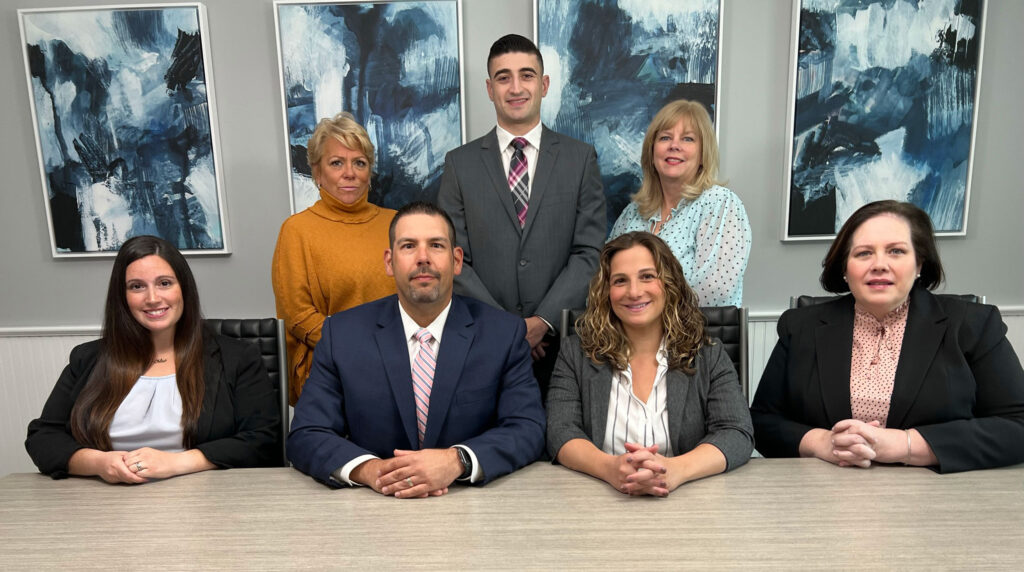 The staff of Long Island divorce lawyers and divorce attorneys at the Long Island, NY divorce law firm Hornberger Verbitsky, P.C. seated at table.