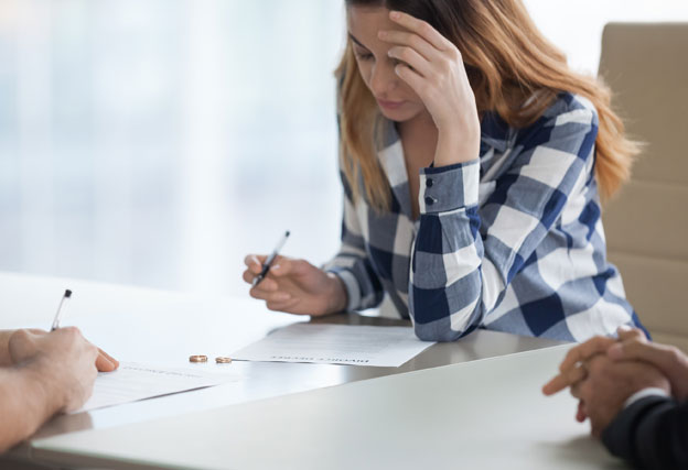 woman signing legal separation papers
