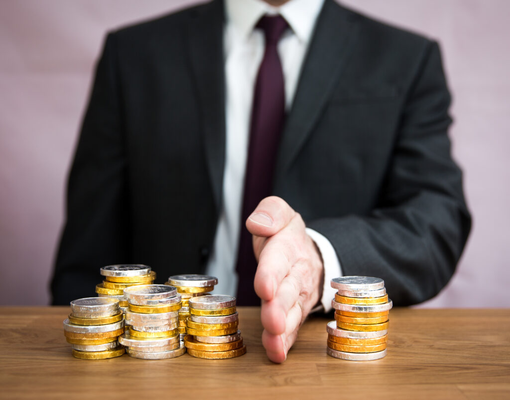 man dividing coins into two piles to represent dividing retirement assets