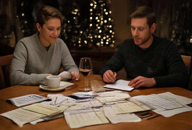 couple at kitchen table pouring over bills