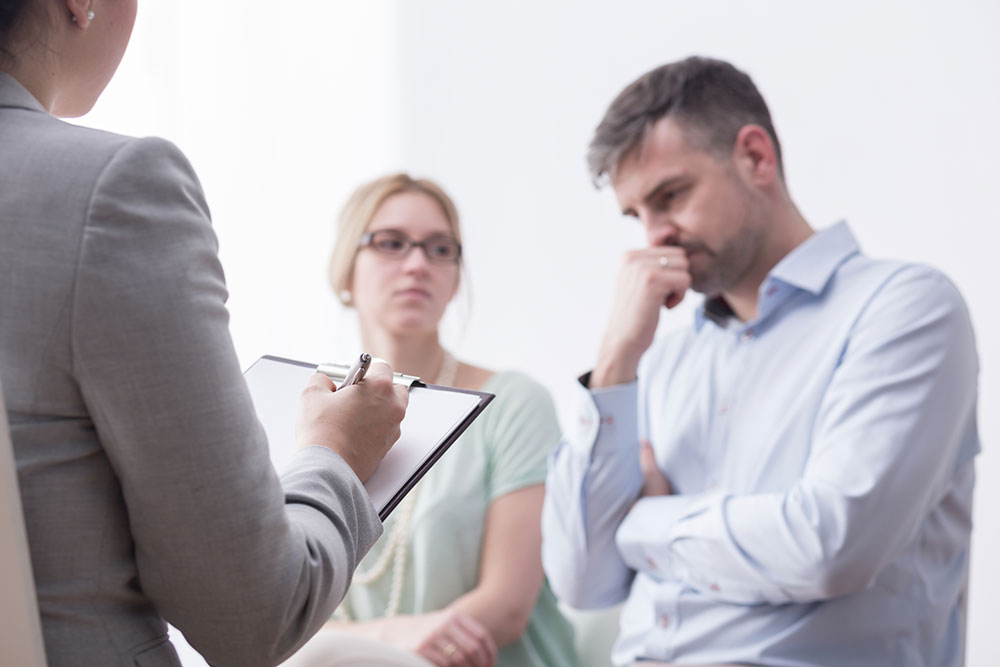 Couple discussing cost of divorce mediation with mediator